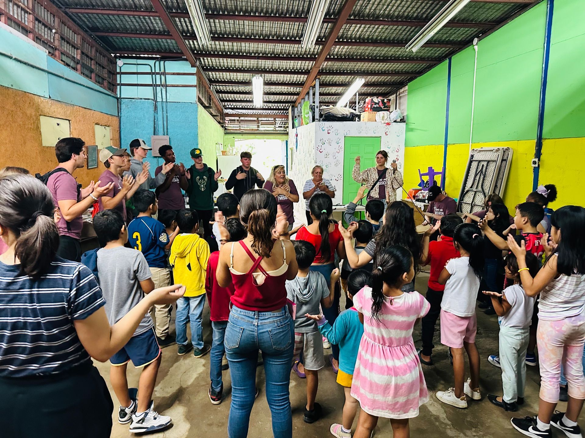 A group of people are dancing in a room.
