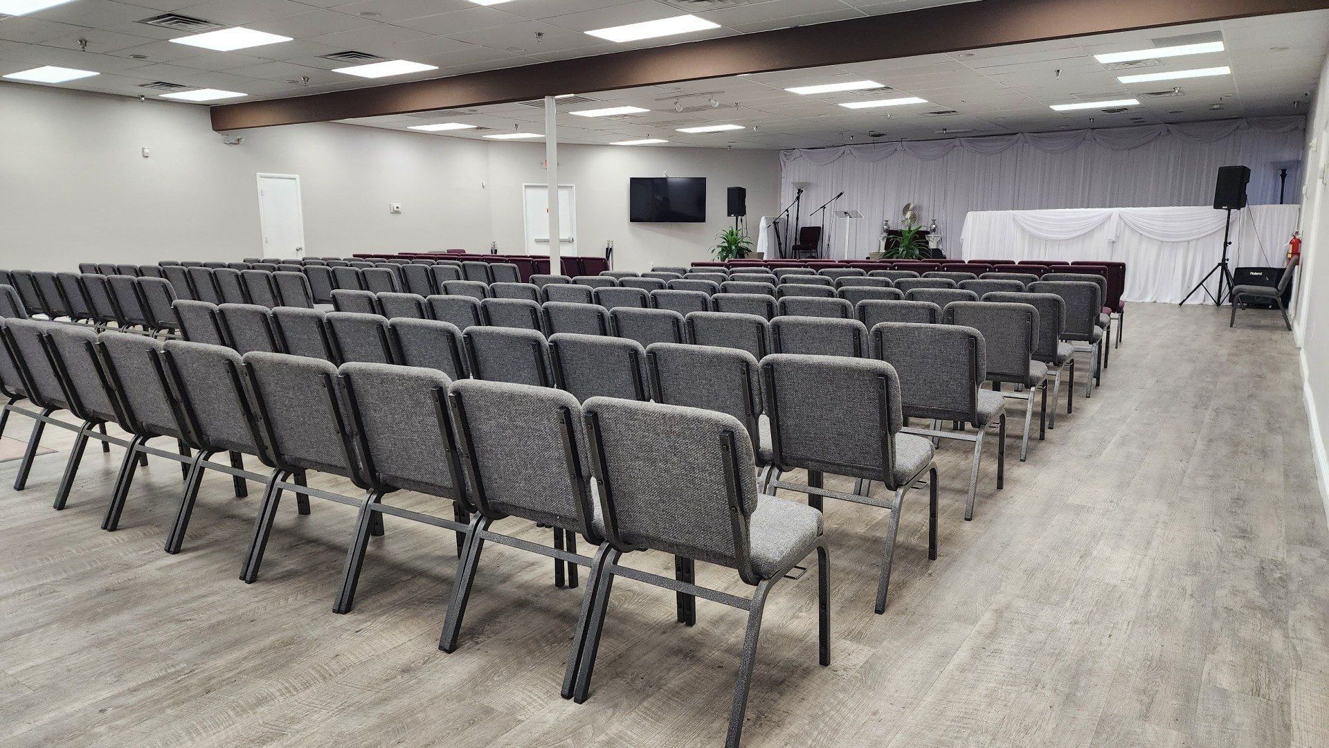 A large room filled with rows of chairs in a church.