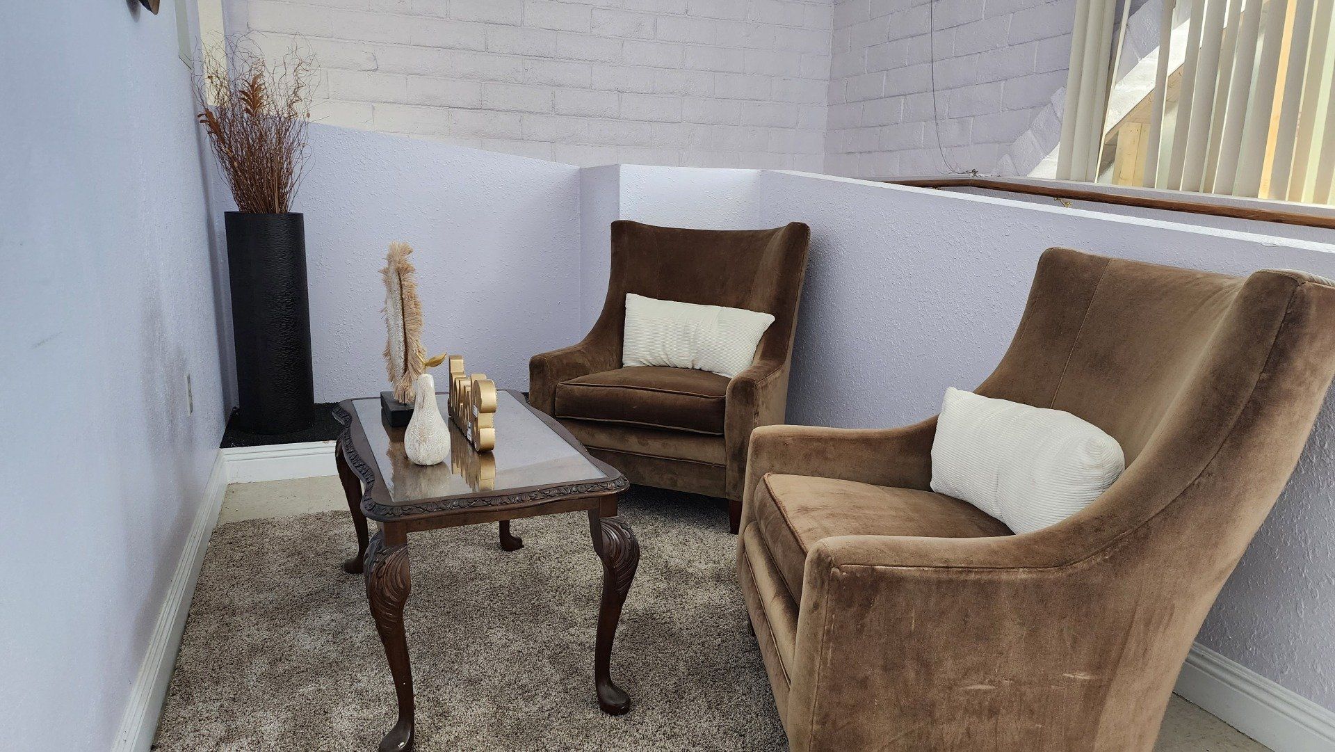 There are two chairs and a table in the room.