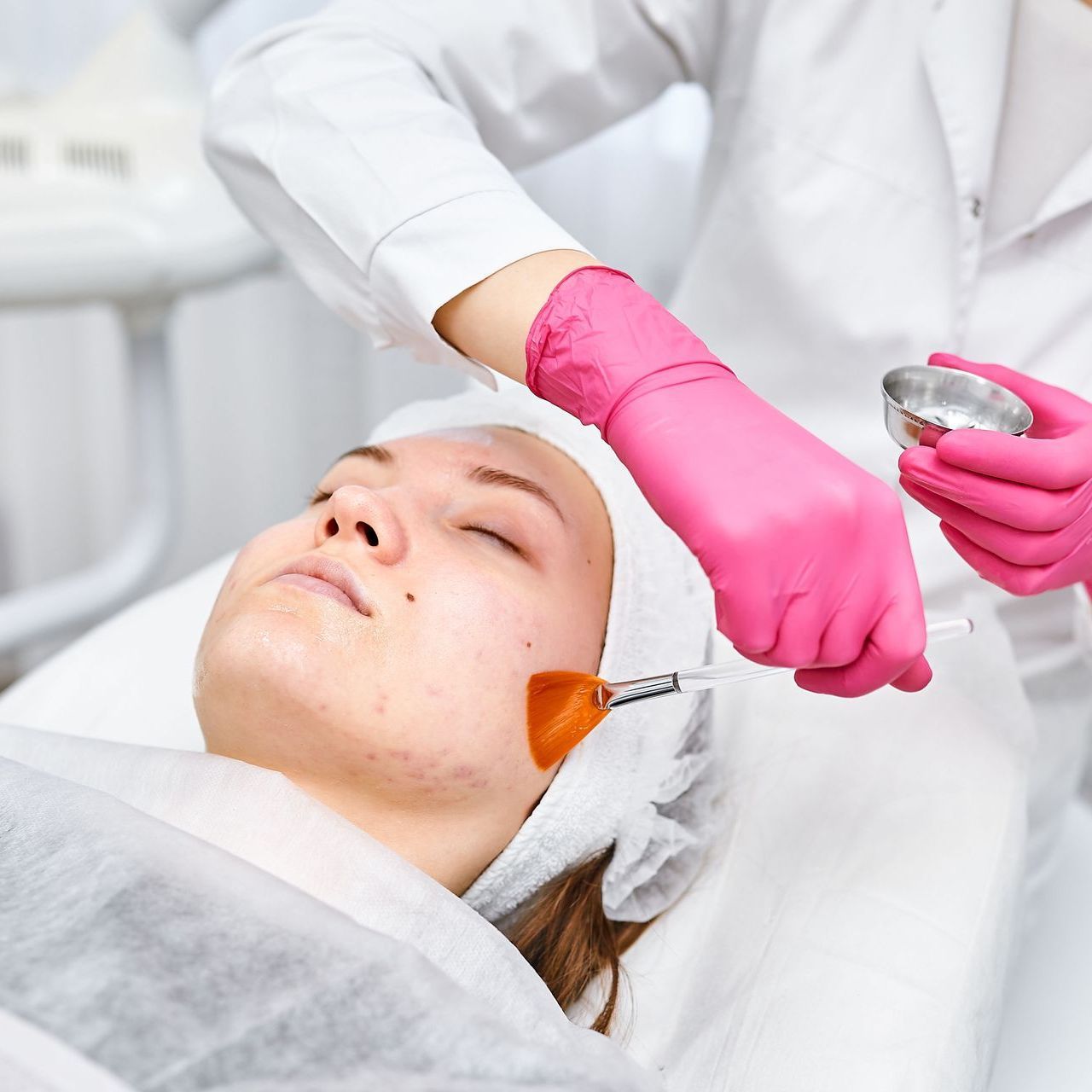 A woman is getting a facial treatment at a beauty salon.
