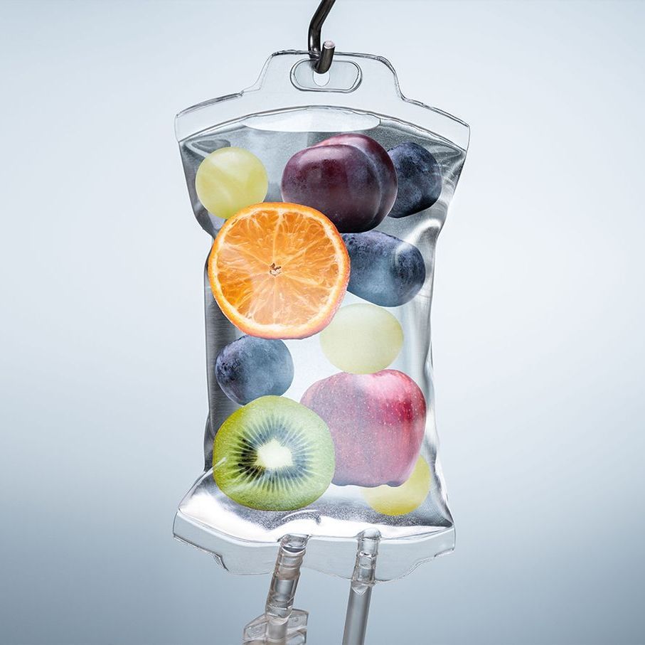 A bag filled with fruit is hanging from a hook.