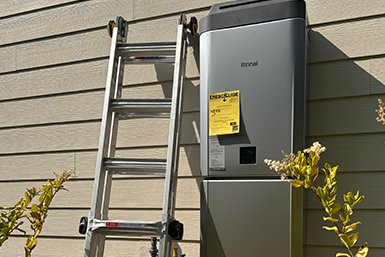 A ladder is leaning against a wall next to a heater.
