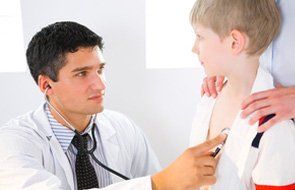 Doctor checking a young boy