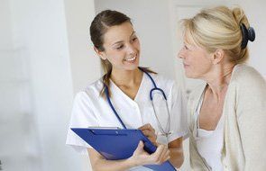 A woman talking to a nurse