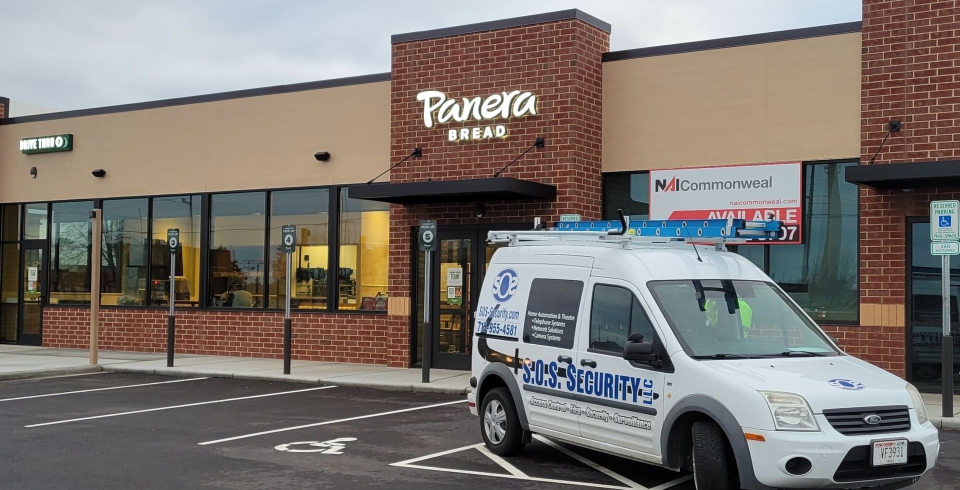 Panera Bread restaurant with a service van parked in front.