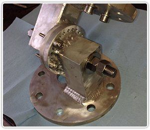 A metallic industrial bracket with a circular base plate, bolt-fastened pivot joint, and welded support structure.