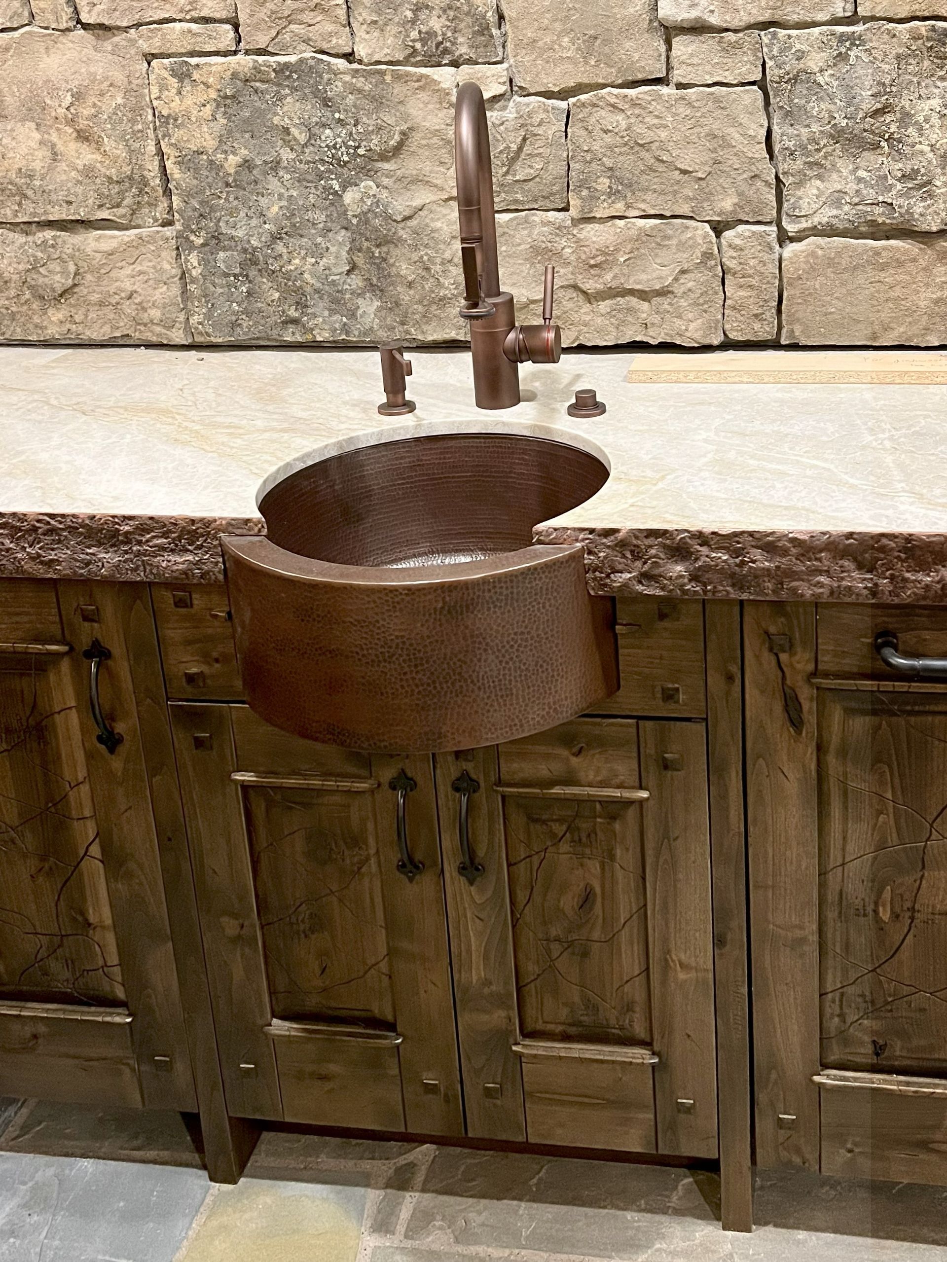 Copper sink and faucet in a rustic style bathroom.