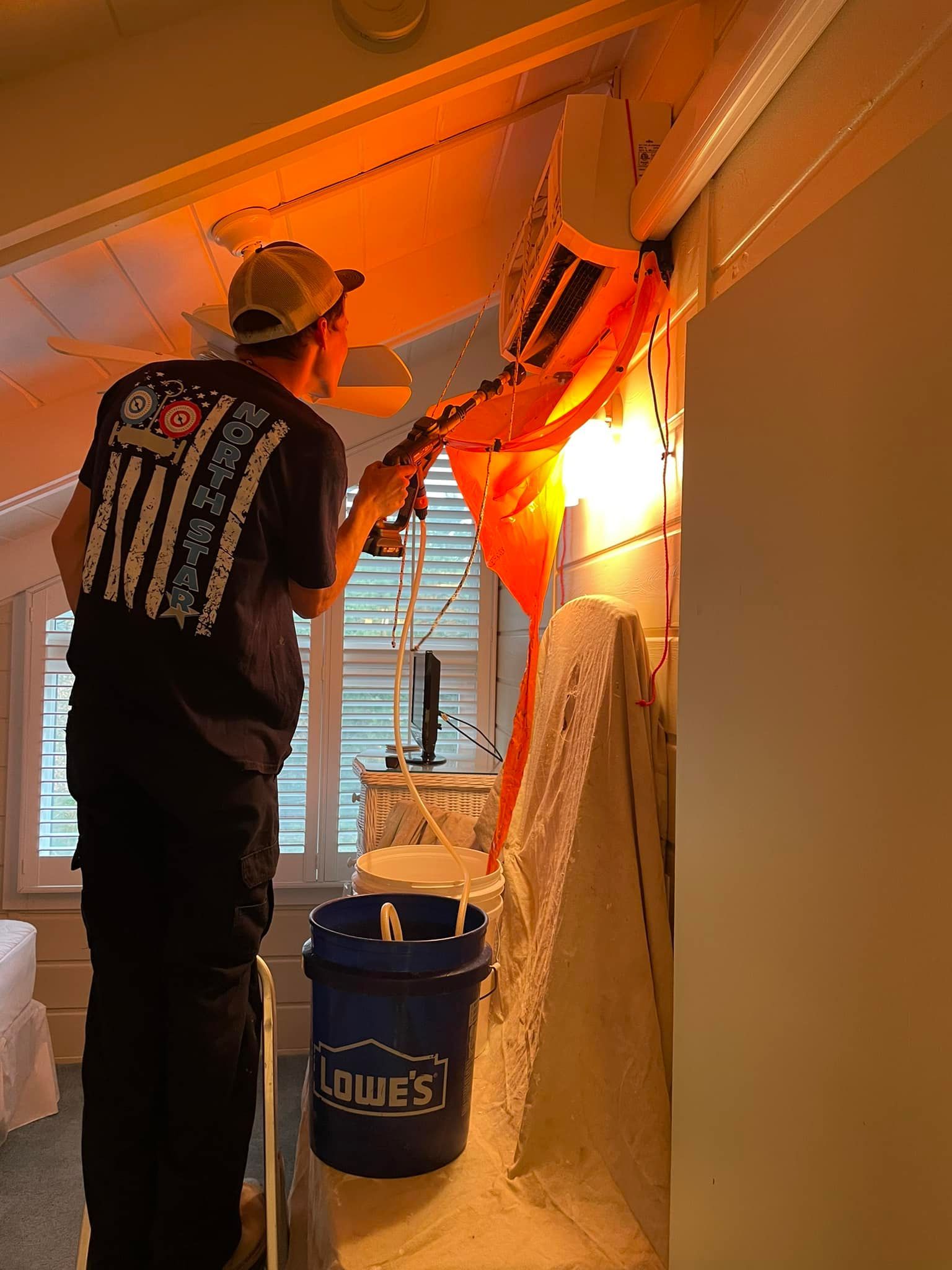 man servicing ductless units