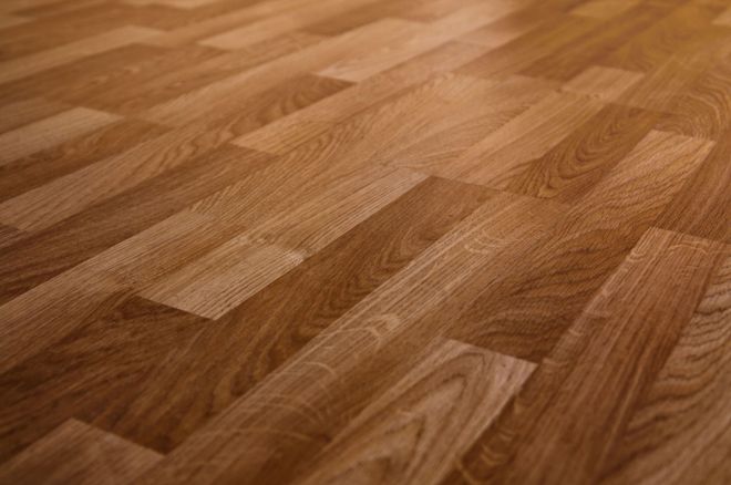 Wooden flooring, medium brown color, angled planks.