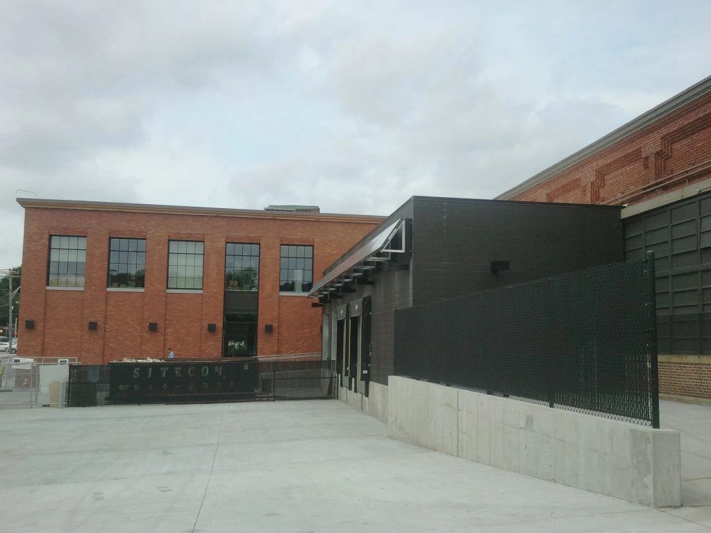 A large brick building with a black fence in front of it