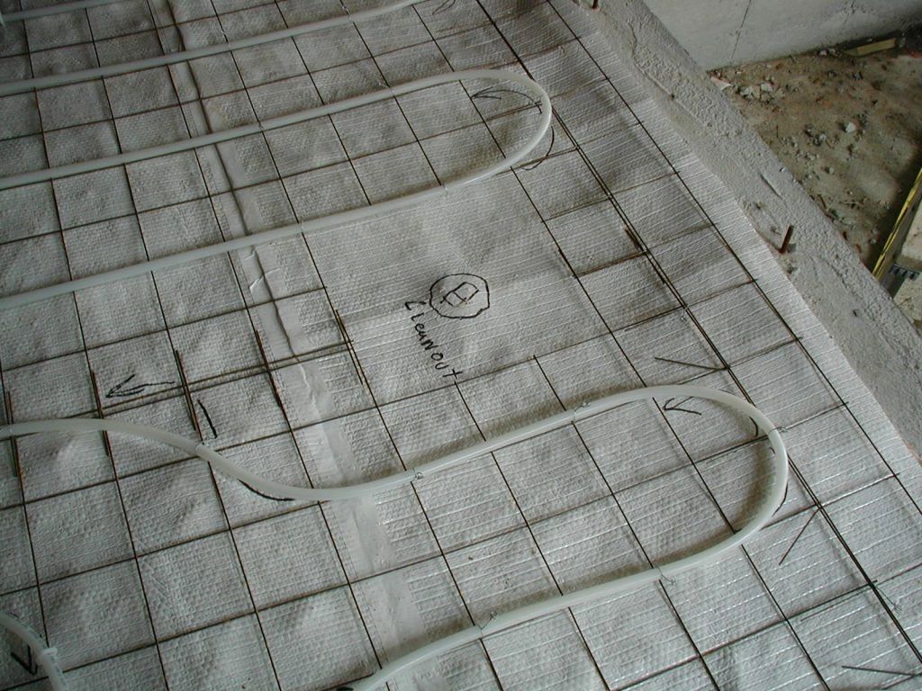 A close up of a heating system on a tiled floor