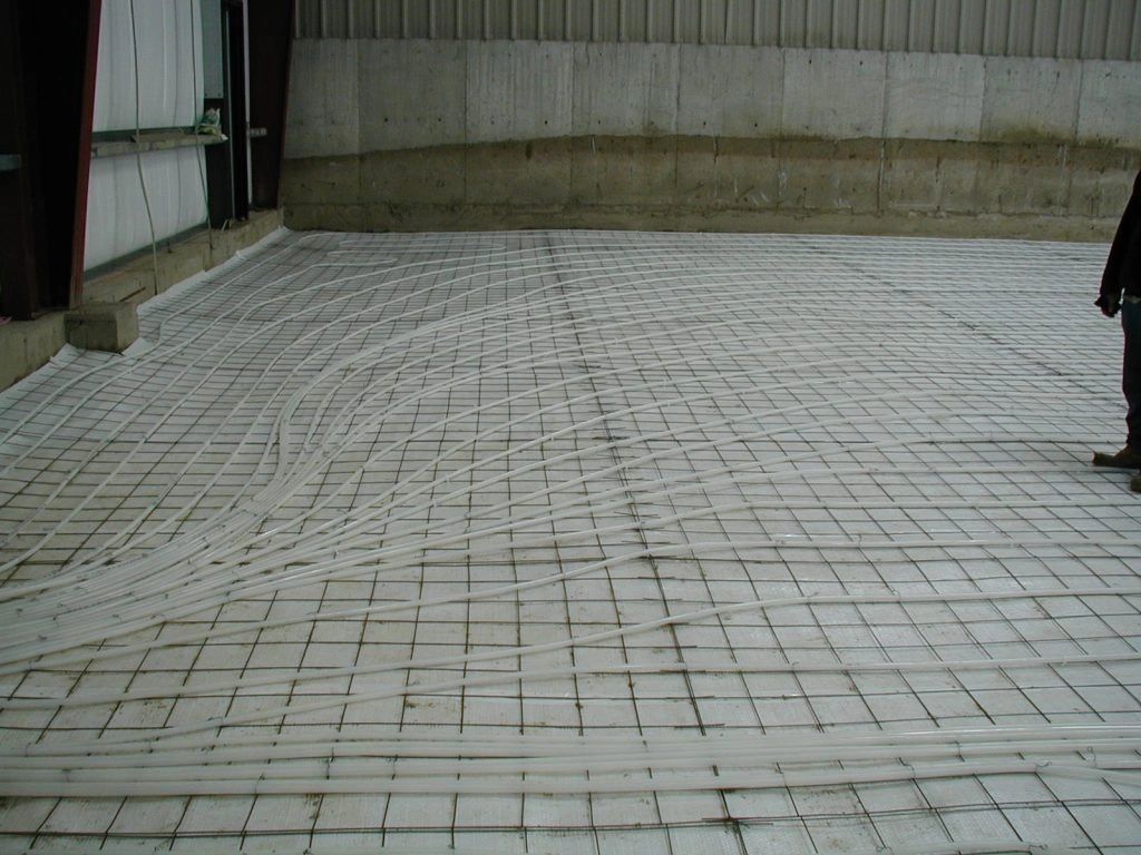 A person standing on a concrete floor with a grid pattern