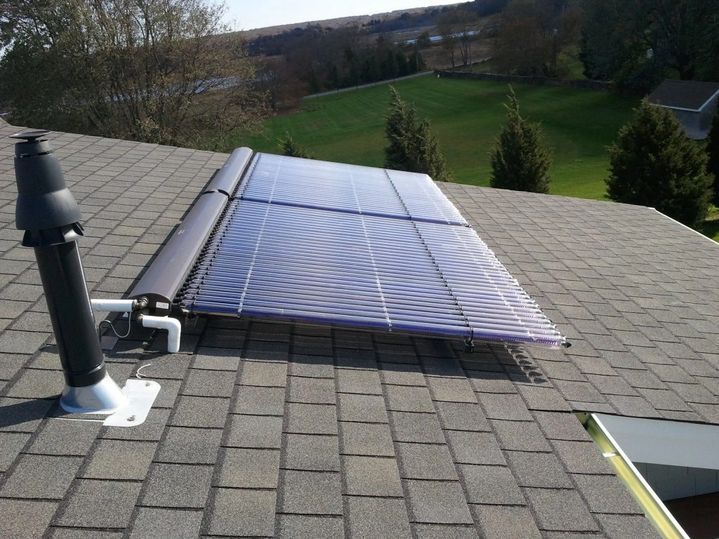 A solar panel is on the roof of a house