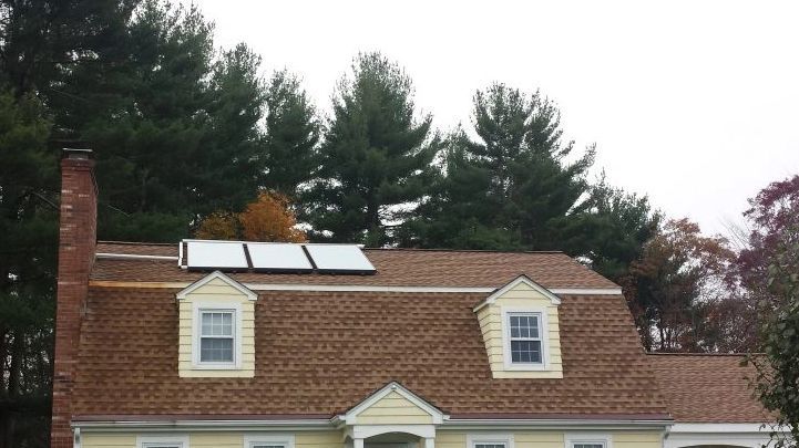 A house with a solar panel on the roof