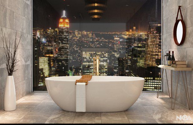 Bathtub in luxury bathroom with city skyline view at night; gold faucet, neutral tones.