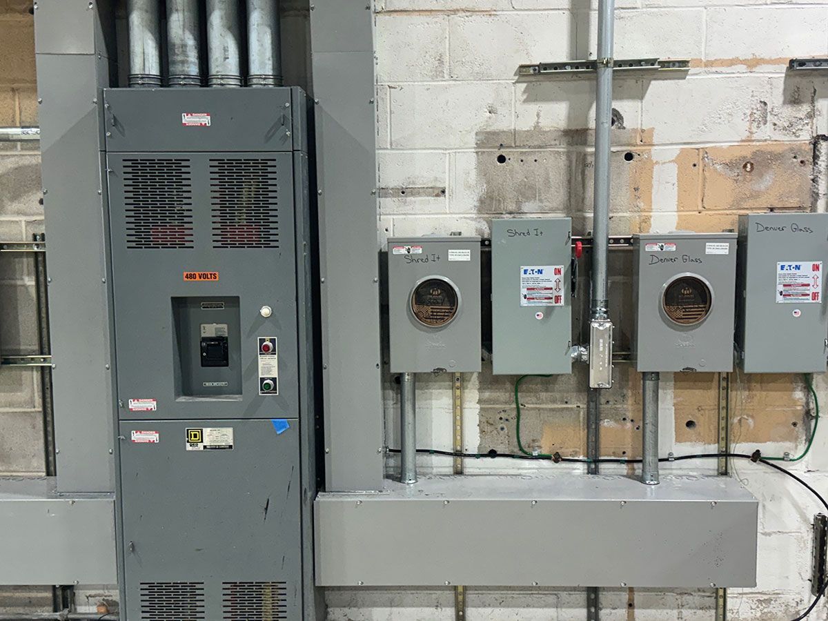 There are a lot of electrical panels on the wall