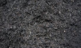 A close up of a pile of black mulch.