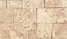 A close up of a brick wall with square tiles.