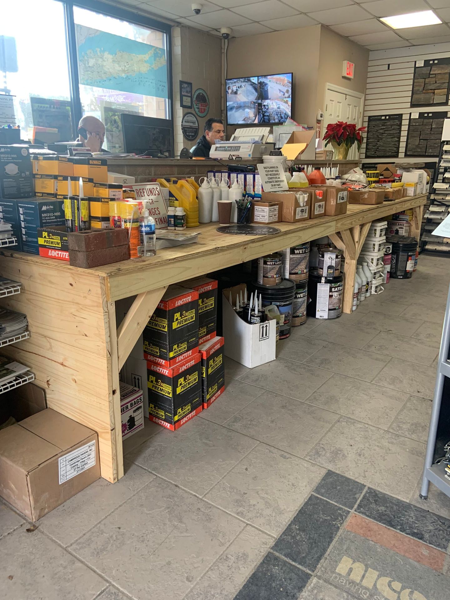 A man is standing at a counter in a store