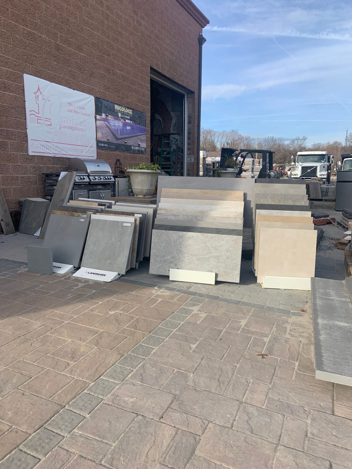 A bunch of tiles are sitting on the ground in front of a building