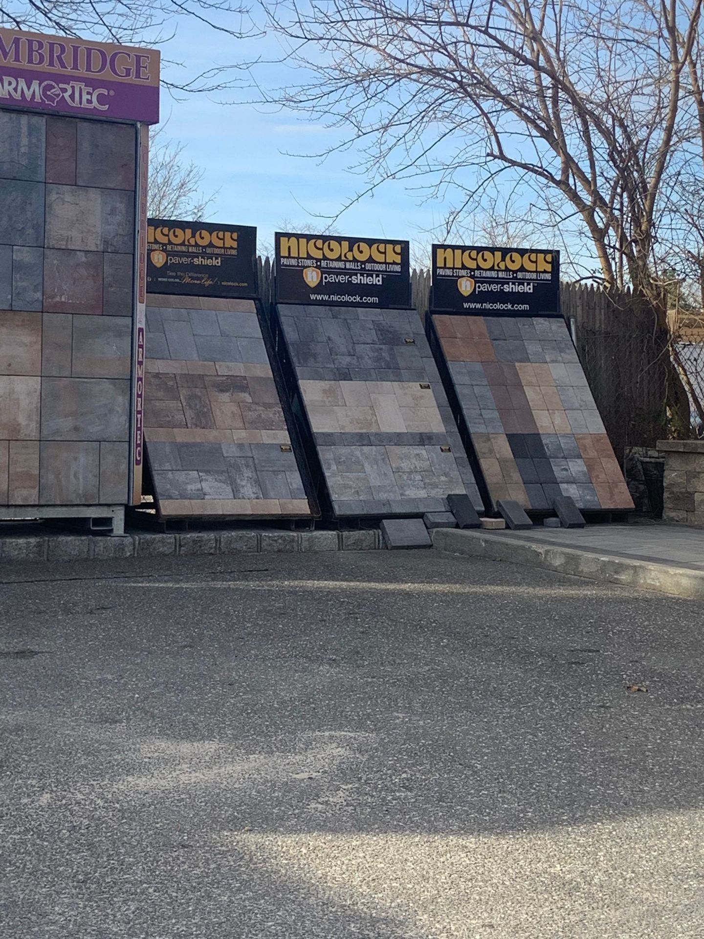 A display of tiles in a parking lot in front of a building