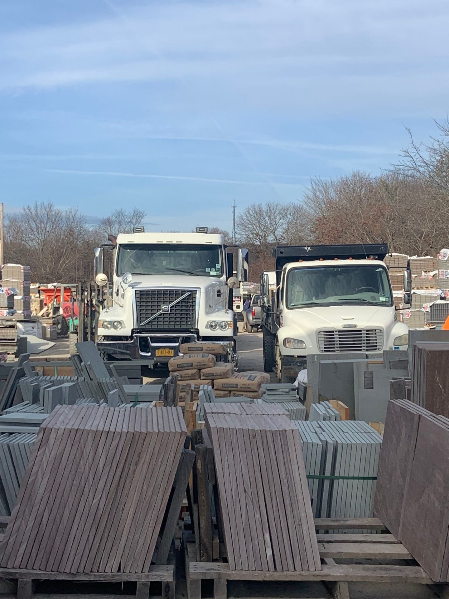 A row of trucks are parked next to each other in a parking lot