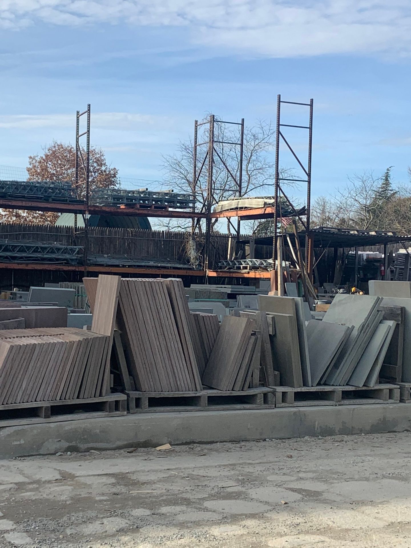A lot of pallets of tiles are stacked on top of each other in a warehouse