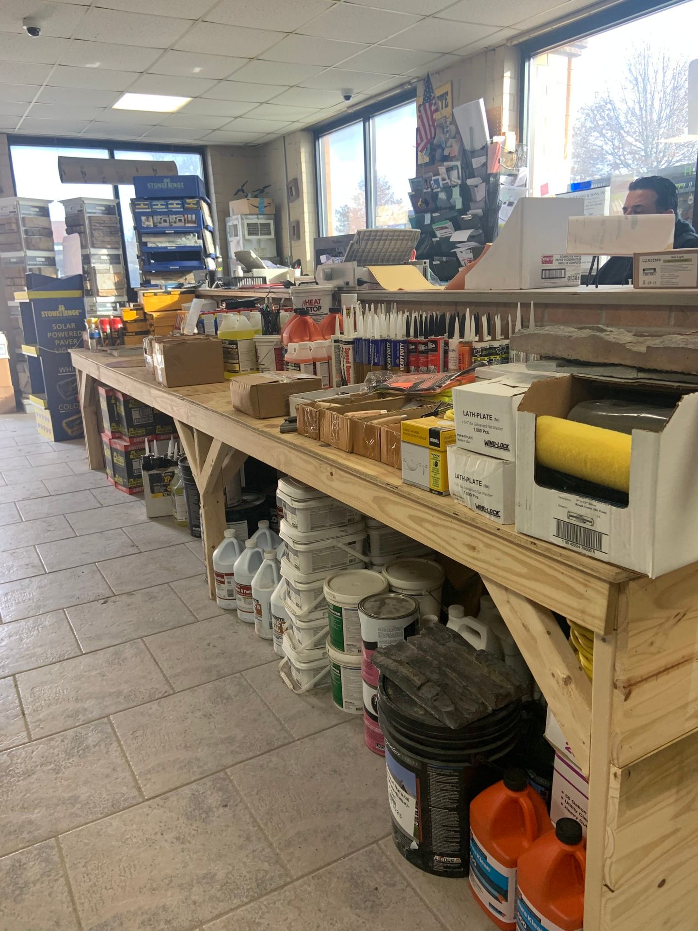 A long wooden table filled with lots of supplies in a store