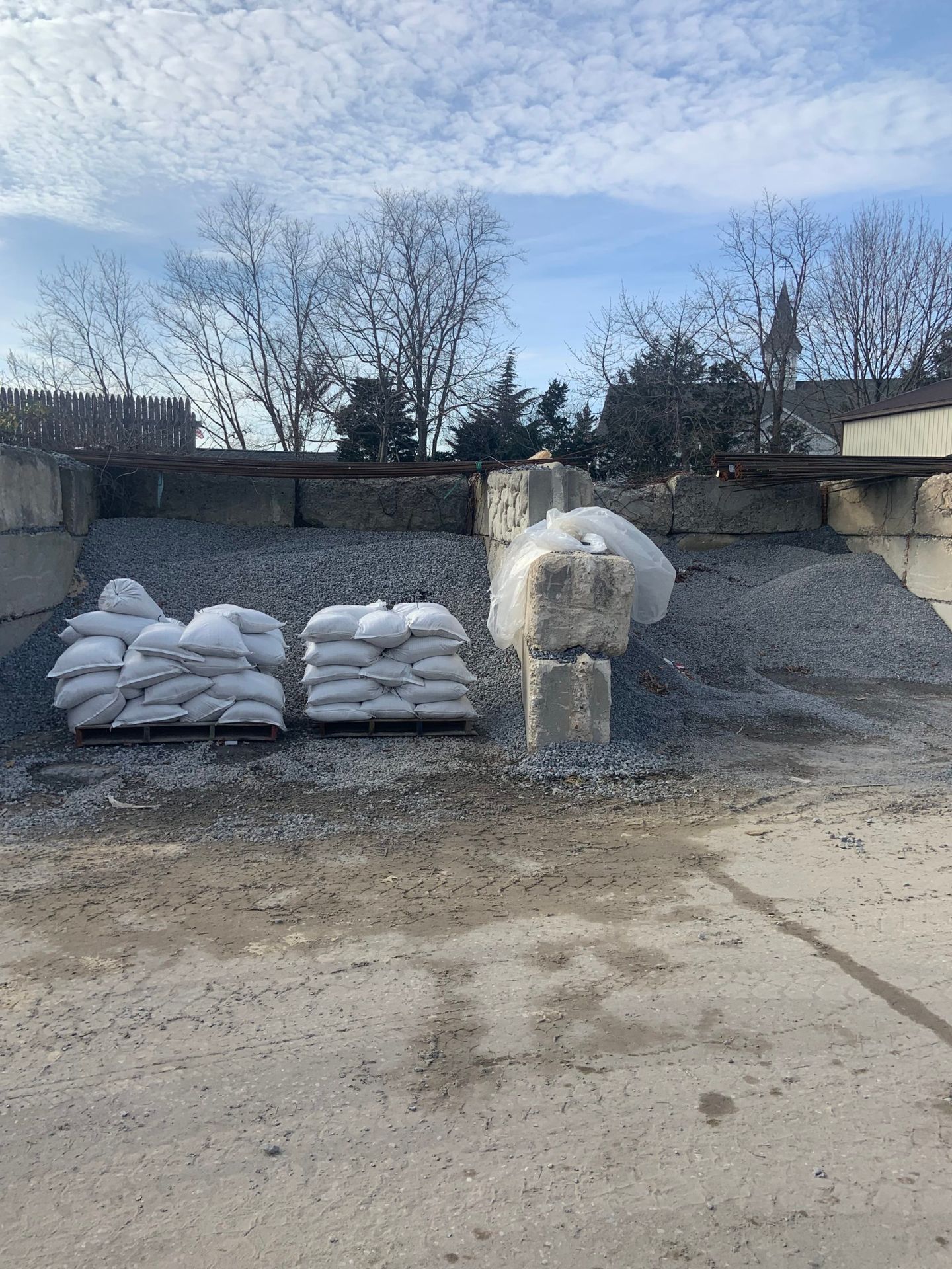 A pile of bags sitting on top of a pile of gravel.