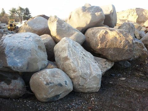 A pile of large rocks is sitting on the ground