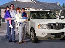 Family standing infront of a car