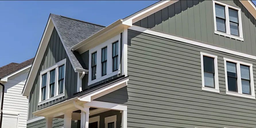 Gray and white house with a blue sky background.
