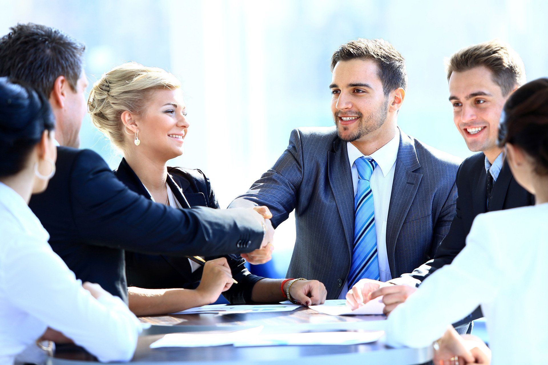 Business team shaking hands during a meeting at a conference table