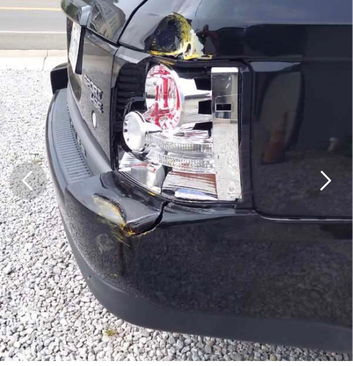 A black range rover with a broken tail light