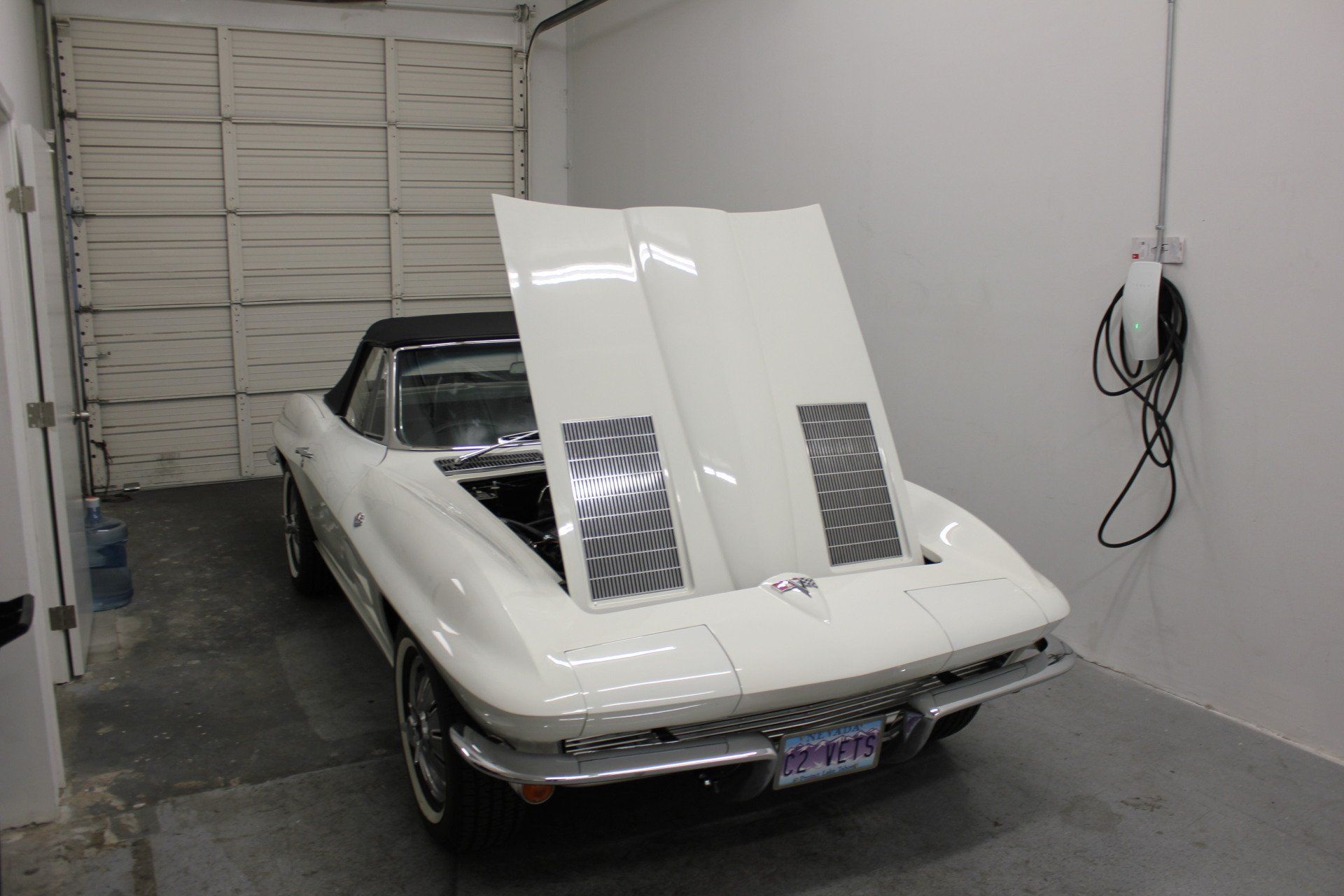 white classic car with the hood up