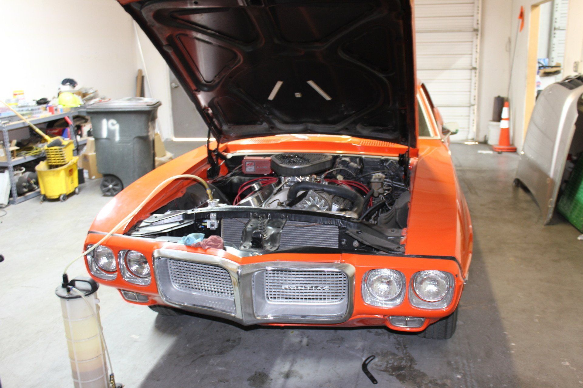 orange muscle classic car with the hood up