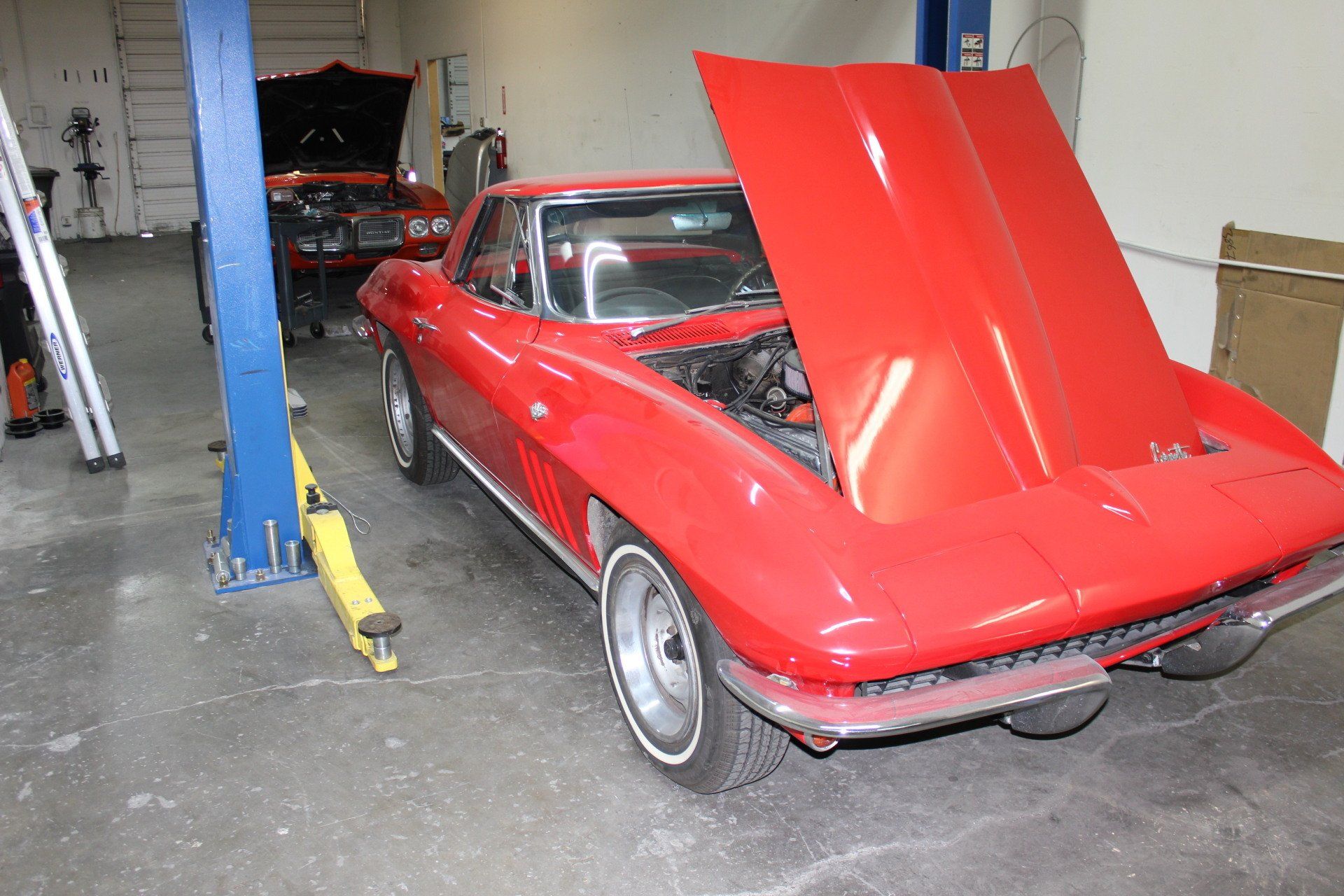 red classic car with the hood up