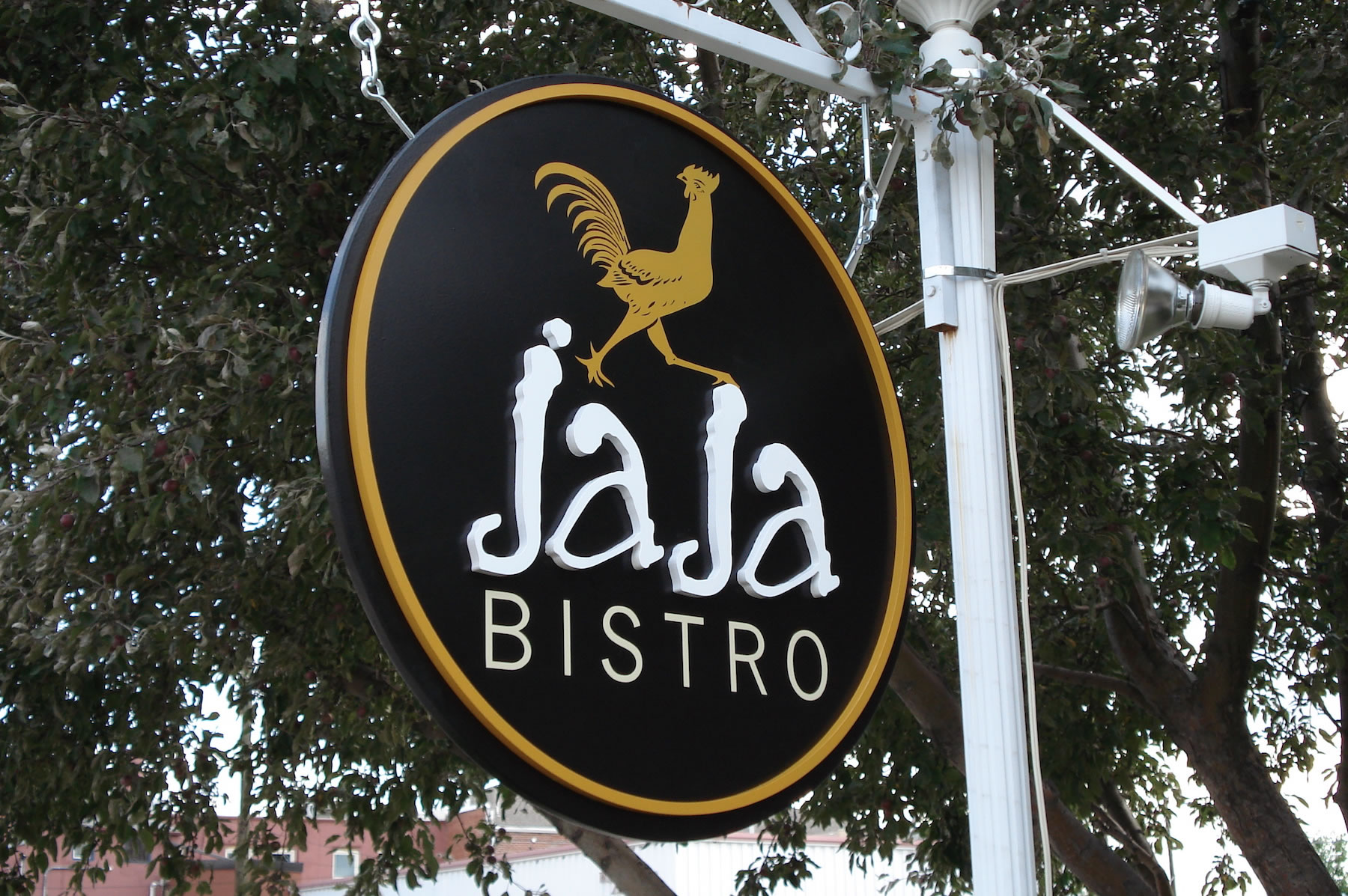 A sign for jaja bistro with a rooster on it