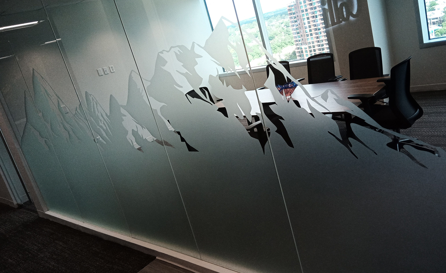 A conference room with a table and chairs in it