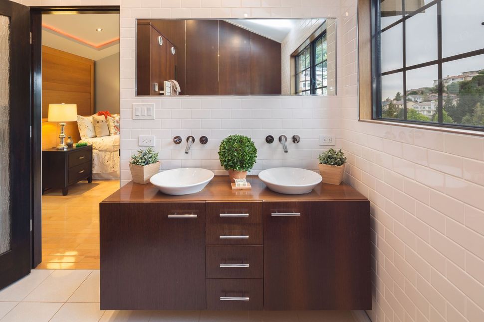 White built-in closet with paneled doors and drawers in a bright room