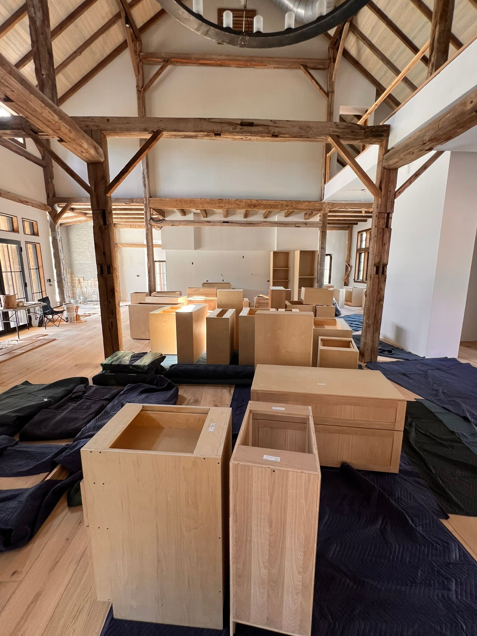An unfinished room with wooden beams and boxes.