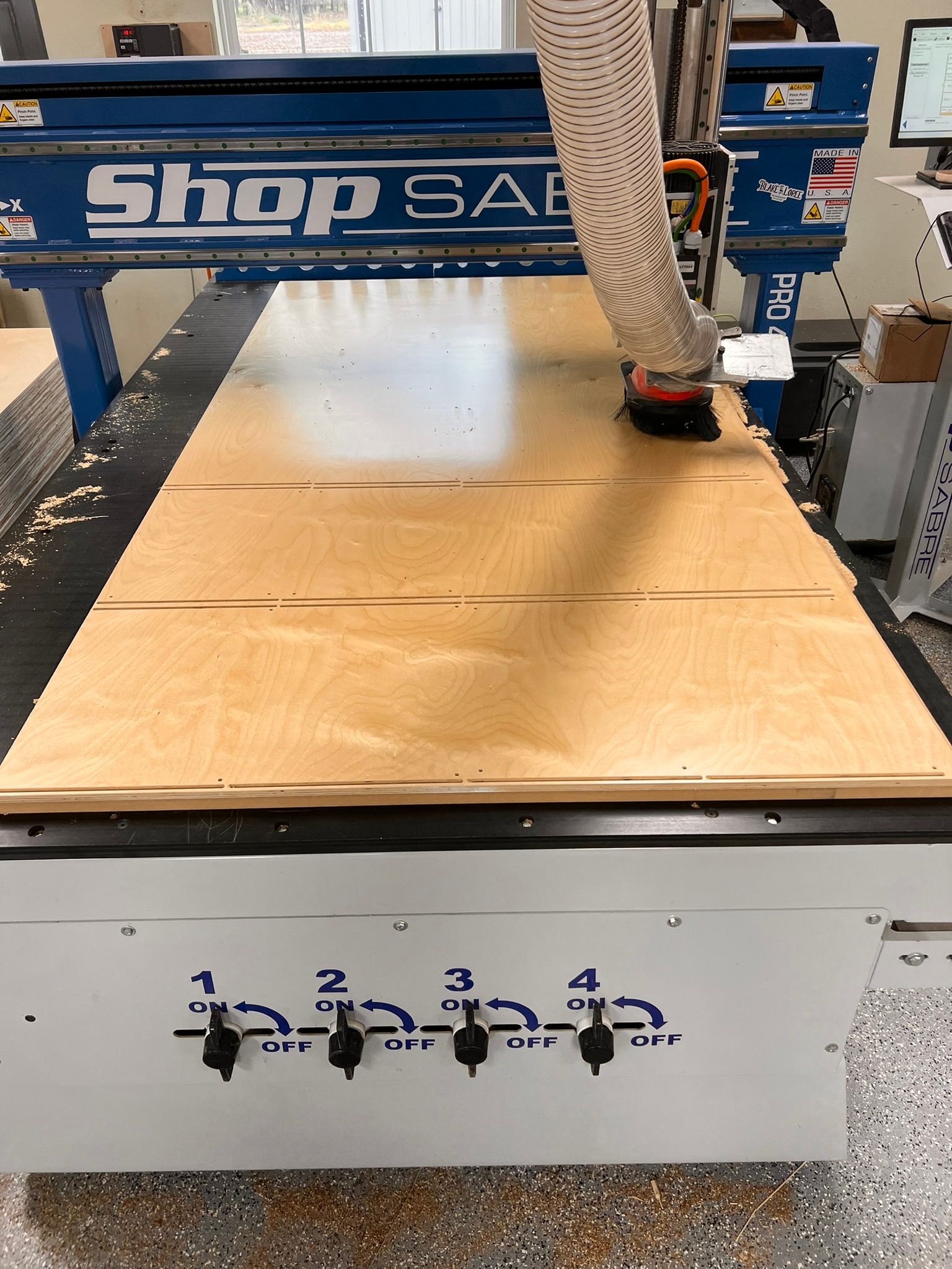 CNC router cutting plywood on a ShopSabre machine.