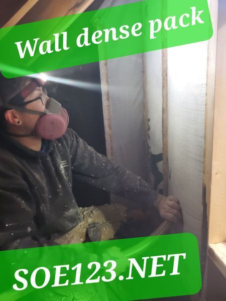 Man wearing respirator, dense packing a wall with material, SOE123.NET logo.