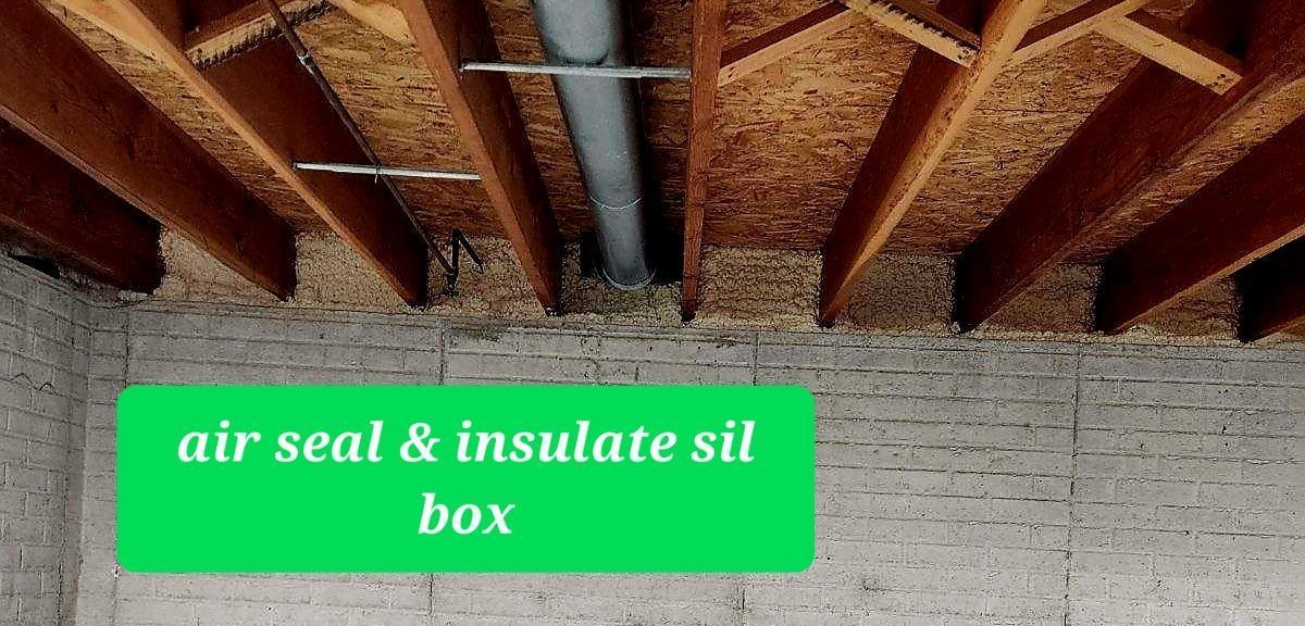 A view of a basement ceiling with wooden beams, a pipe, and a green rectangle reading 