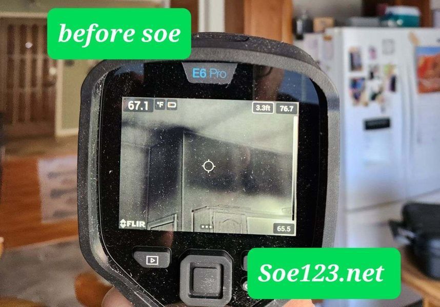 Thermal camera displaying a gray, rectangular wall, with temperature readings visible.