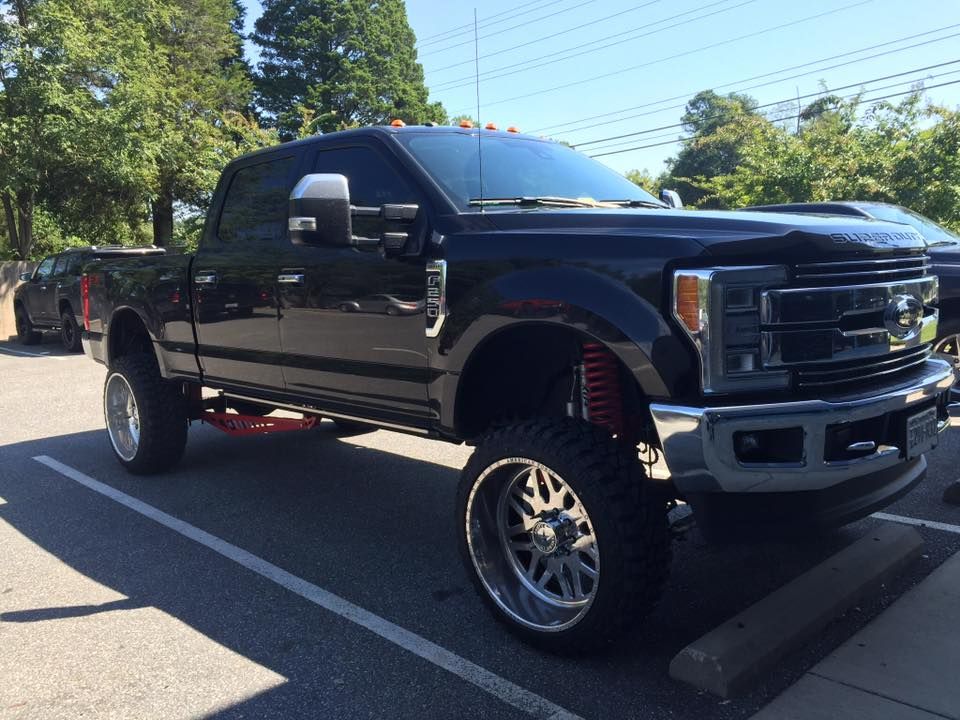A black pickup truck is parked in a parking lot