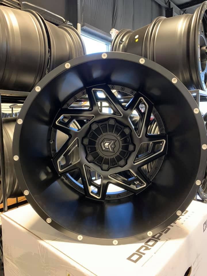 A black wheel is sitting on top of a white box.