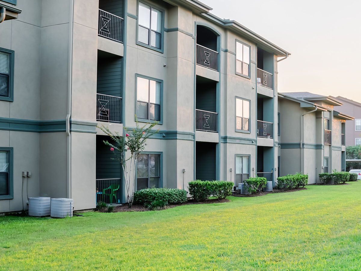 Apartment building with balconies and green lawn