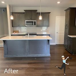 A kitchen with a large island and a microwave.