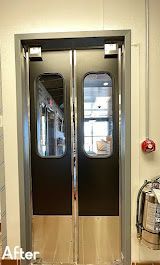 A pair of black doors with glass windows in a room.